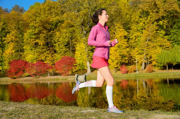 Vrouw met najaar park, mooi meisje loper joggen buiten — Stockfoto