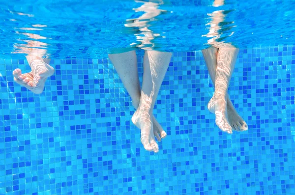 Funny underwater family legs in swimming pool — Stock Photo, Image