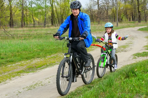 Happy father and child on bikes, family cycling — Stock Photo, Image