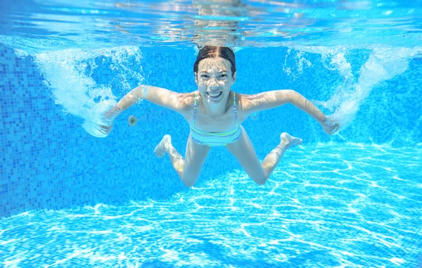 Happy child swims in pool underwater, active kid swimming, playing and having fun, children water sport — Stock Photo, Image