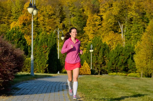 Frauenlauf im Herbstpark, schöne Läuferin beim Joggen im Freien, Training für Marathon, Bewegungs- und Fitnesskonzept — Stockfoto