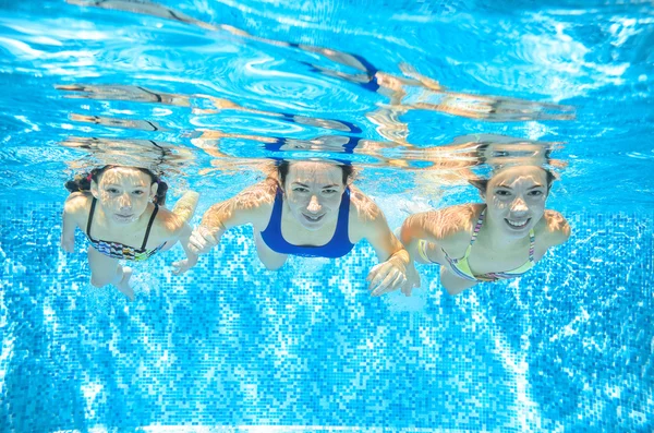 Family swim in pool underwater, happy active mother and children have fun under water, kids sport on family vacation — Stock Fotó