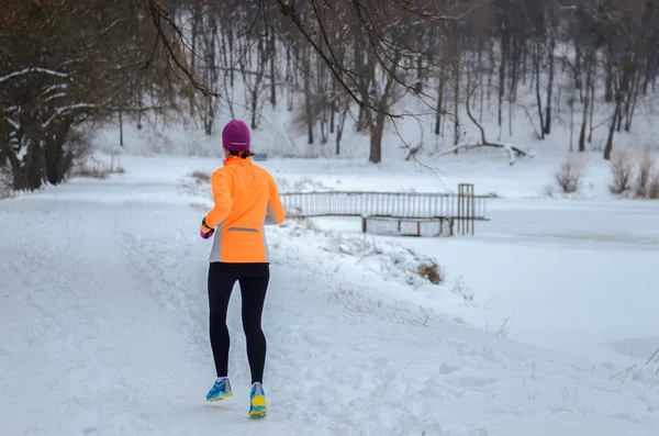 Inverno nella foresta: felice donna corridore jogging nella neve, sport all'aria aperta e concetto di fitness — Foto Stock