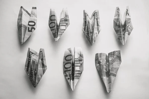 Banknotes are folded in the form of airplanes. Losses, financial problems, lack of funds. In black and white. View from above. — Stock Image Banknotes Folded Form Airplanes Losses Financial Problems Lack Funds Black Stock Photo