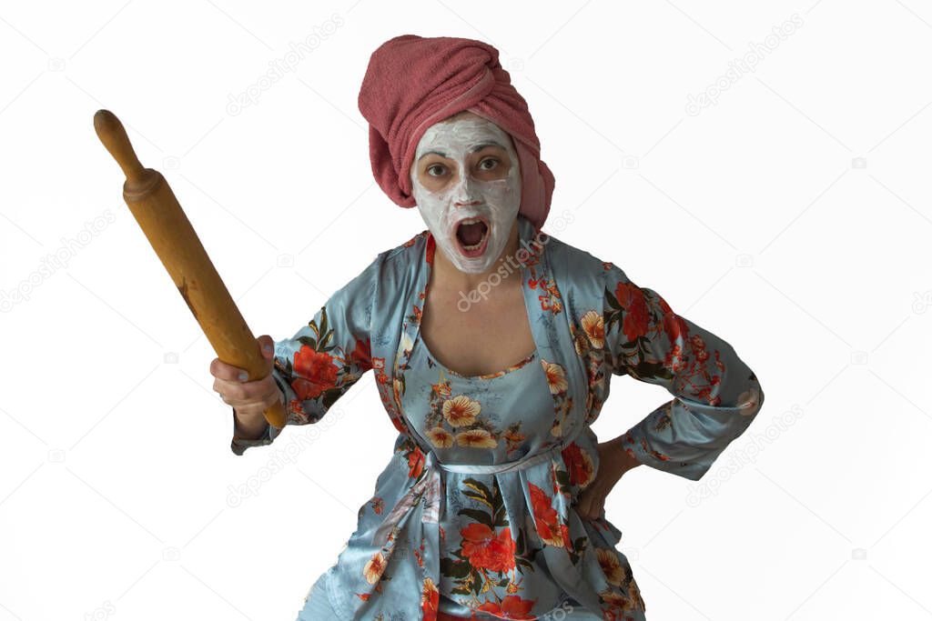 An angry wife attacks. Awesome pose, in the hands of wooden utensils. Family conflict, quarrel.