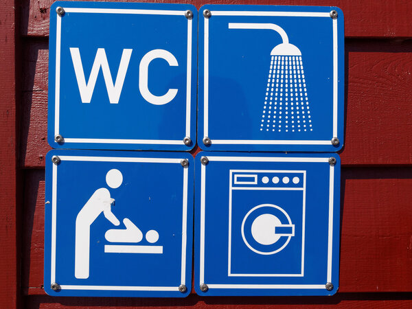 Blue sign of public toilets WC shower washing machines baby