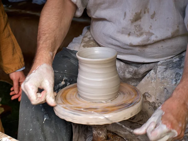 Hands working on pottery wheel — Stock Photo, Image