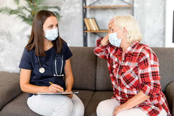 Doctor and patient in medical masks at home.