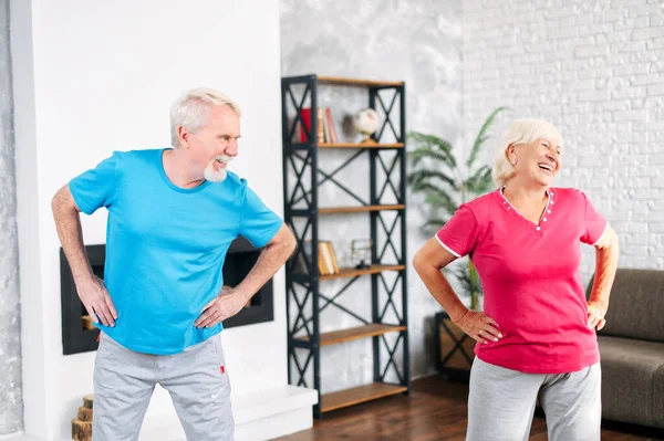 Senior couple doing sports at home