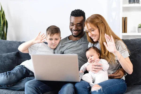 A multiracial family on the couch at home — Stock Photo, Image