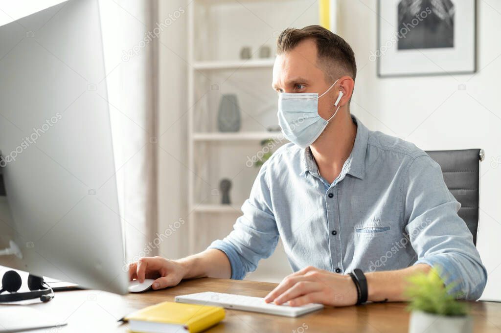 A woman in medical mask in the office