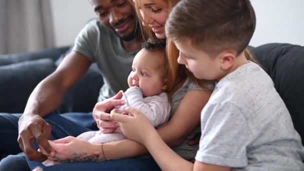 Eine multiethnische Familie auf der heimischen Couch — Stockvideo