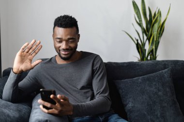 Akıllı telefonu olan Afro-Amerikalı bir adam.