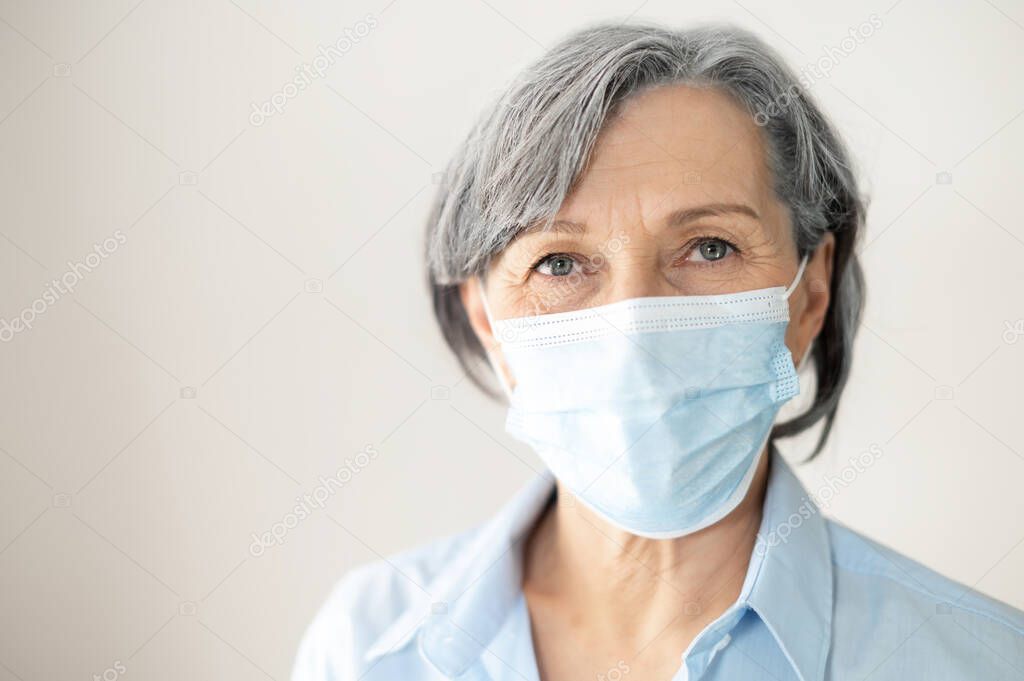 Middle aged female businesswoman in a face mask