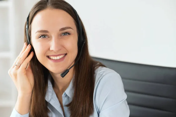 A female with a headset in the office — Stock Photo, Image