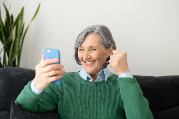 Senior lady excited to read good news online