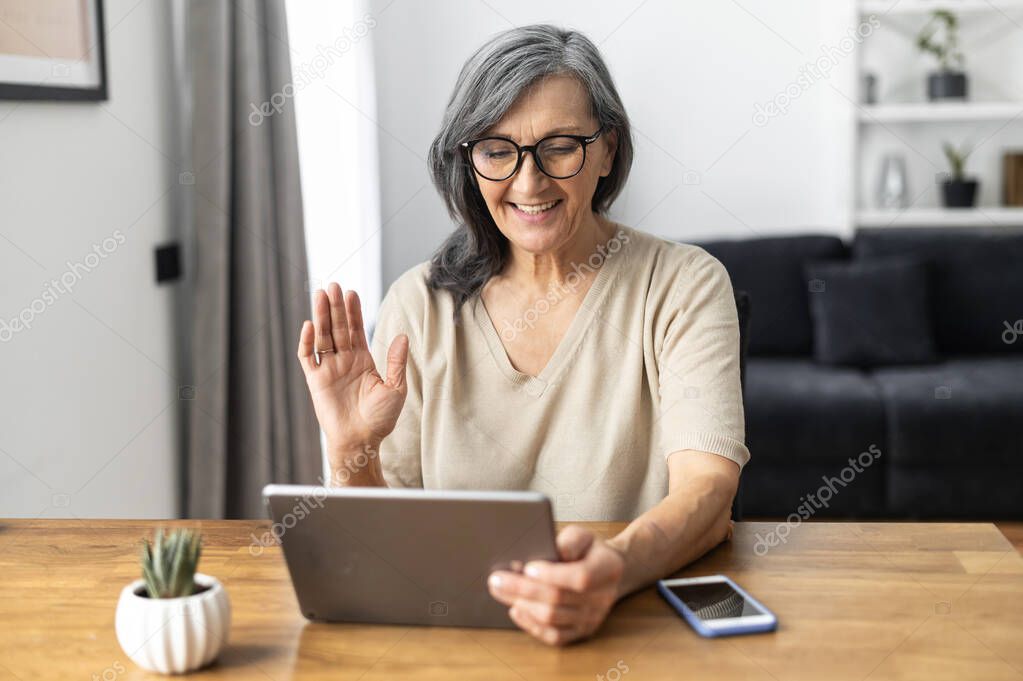 Modern senior woman using a tablet