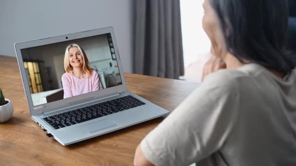 Mujer de mediana edad utilizando el ordenador portátil para videollamada — Vídeo de stock