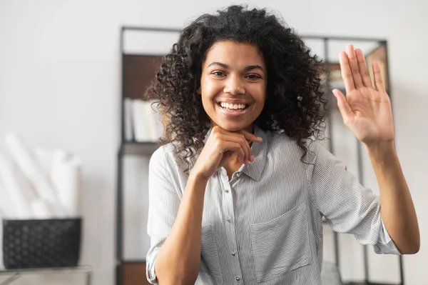 African American office worker waving at camera — Stock Photo, Image