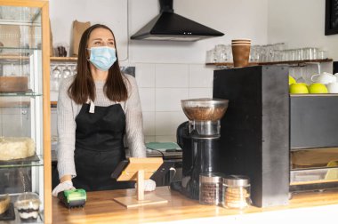 Tıbbi maskeli bir garson.