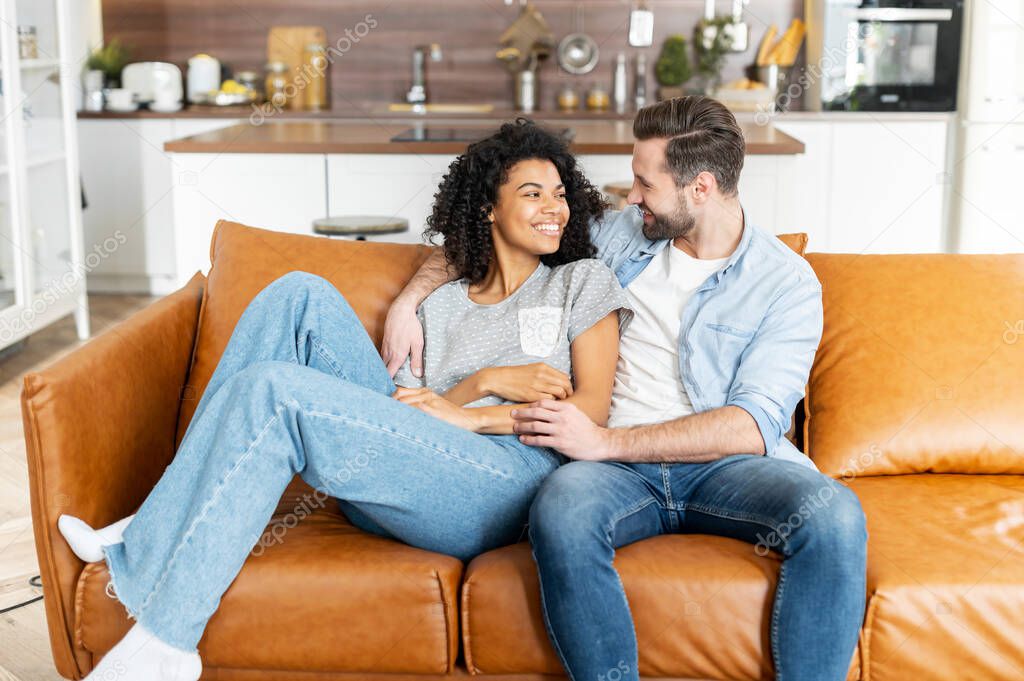 Multiracial couple in love on the couch