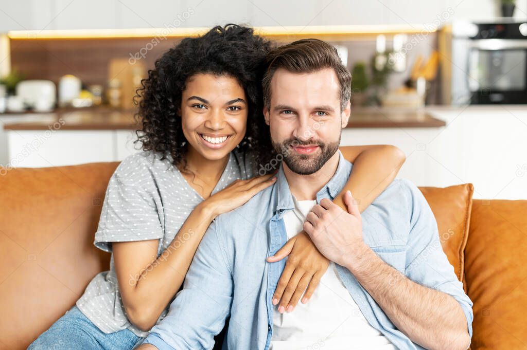 Multiracial couple in love on the couch