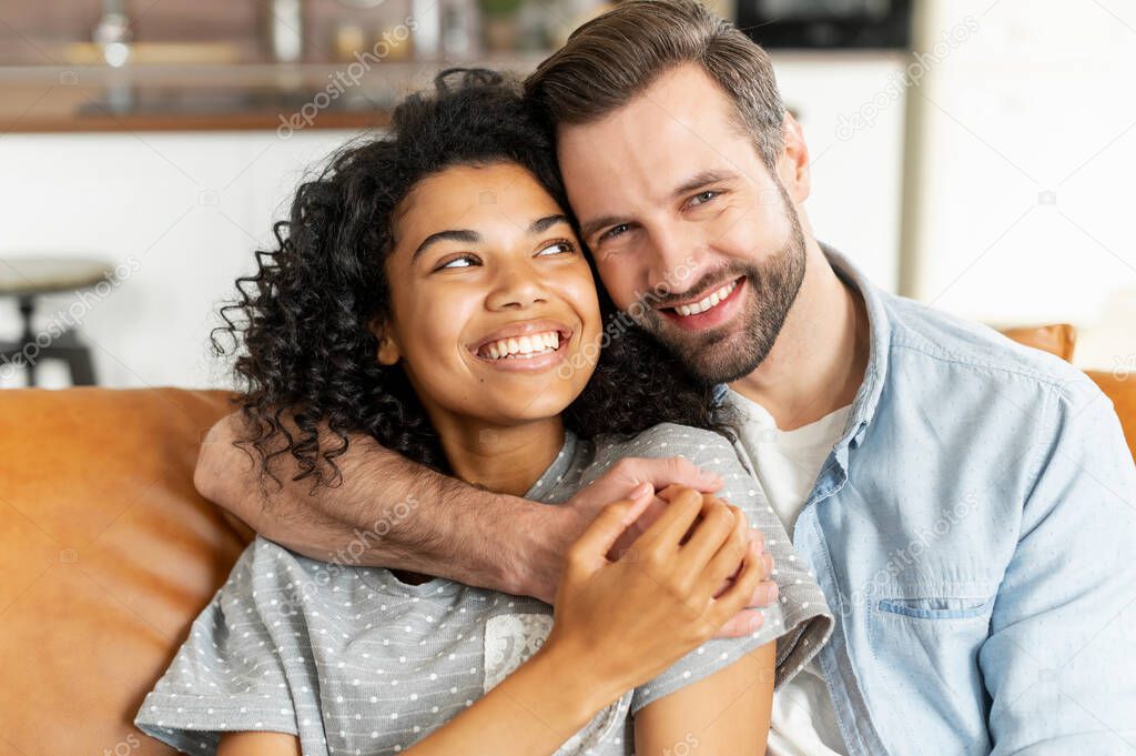 Multiracial couple in love spends leisure at home