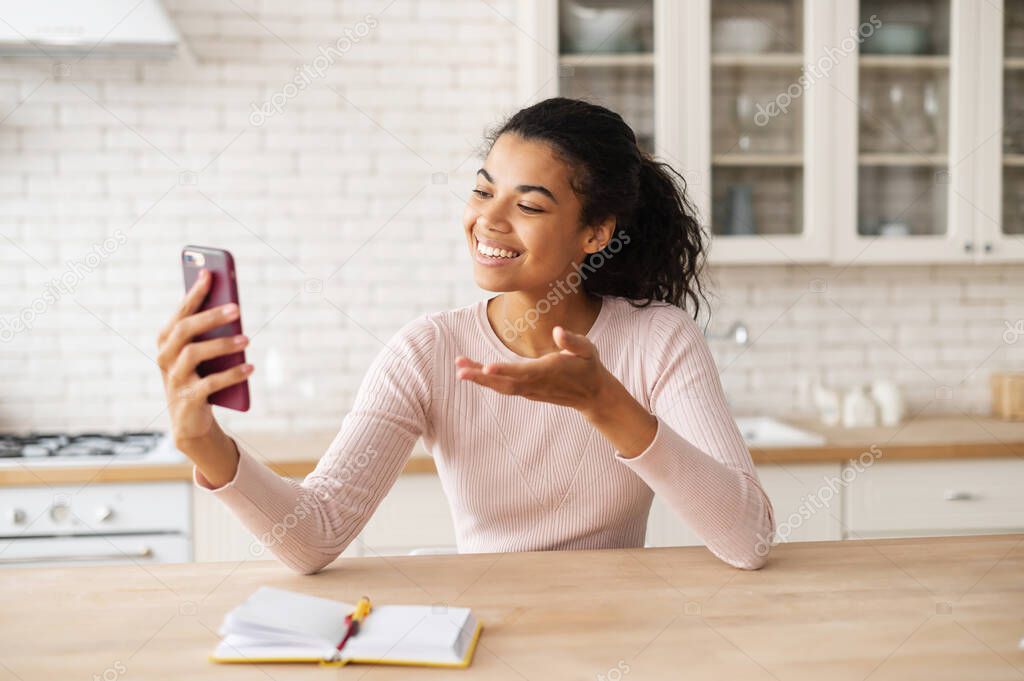 Young latin girl using smartphone for video call