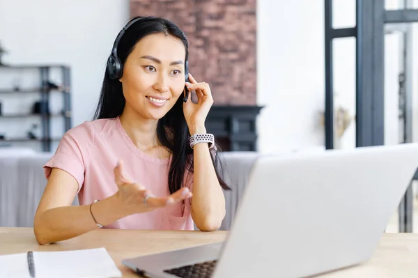 Asian businesswoman having a call via laptop