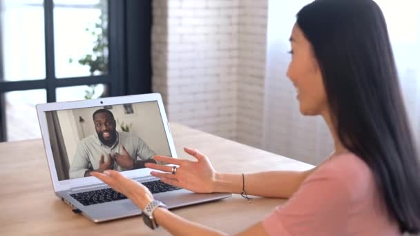 An attractive young asian woman is using a laptop for video call — Stock Video