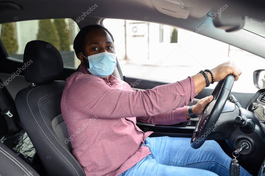 African American male taxi car in a face mask