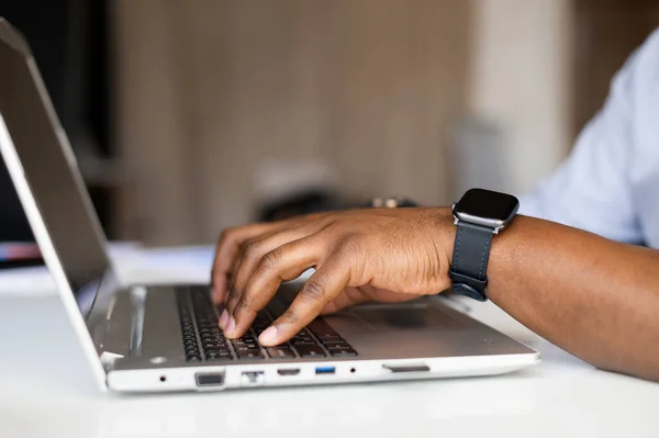 Side profile cropped photo of businessman hands on keyboard of laptop