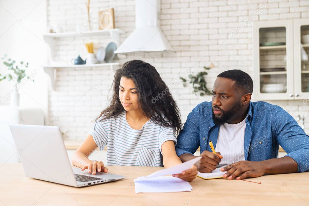 African-American couple calculating finance at home