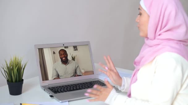 Moslim vrouw draagt hijab met behulp van een laptop voor videogesprek — Stockvideo