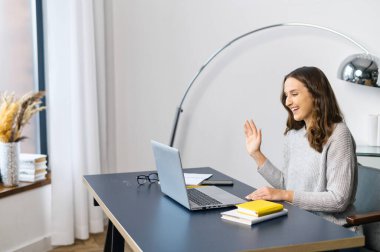 Genç bayanın ofisteki bilgisayarında görüntülü arama var.