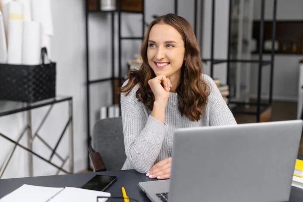 Dizüstü bilgisayarı olan genç bir kadın gülümsüyor — Stok fotoğraf