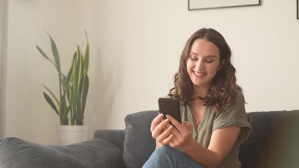 Fröhliche junge Frau nutzt Handy für Videoanruf — Stockvideo