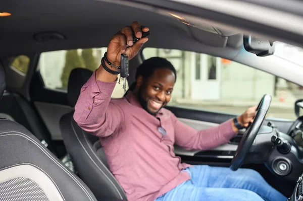 Cheerful black guy buying a car
