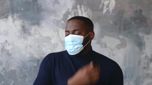 Ung afroamerikan tar av sig medicinsk mask — Stockvideo
