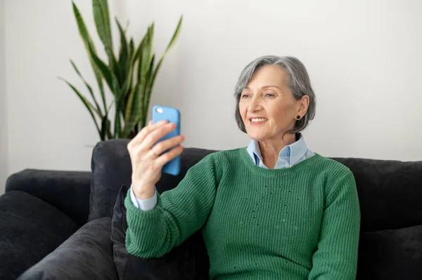 Excited senior lady facetiming her old friend — Stock Photo, Image