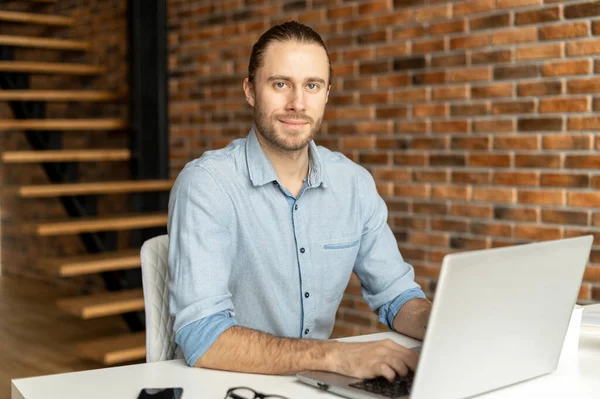 A guy in smart casual wear is using a laptop — Stock Photo, Image