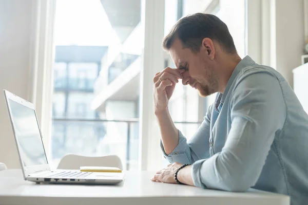 Tired young businessman has vision problem after long-time work with a laptop — Stock Photo, Image