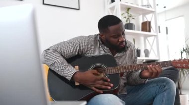 Afrikalı bir Amerikalı gitar çalıyor.
