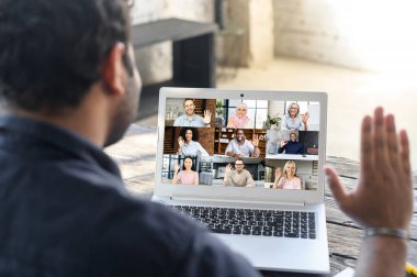 Video toplantısı için laptop uygulaması kullanan çok ırklı bir adam