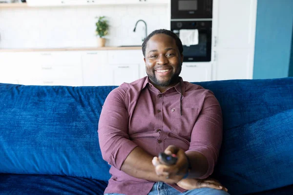 Glada och glada afroamerikanska man med dreadlocks håller TV fjärrkontroll — Stockfoto