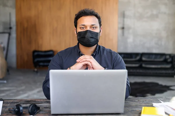 직장에서 얼굴을 보호하는 마스크를 쓴 걱정하는 이 디언의 모습 — 스톡 사진