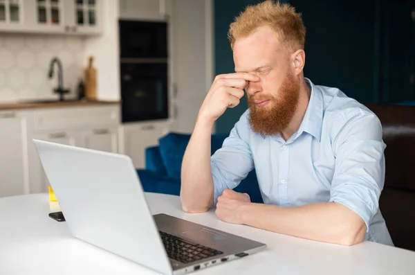 Exhausted redhead businessman in smart casual shirt — Stock Photo, Image