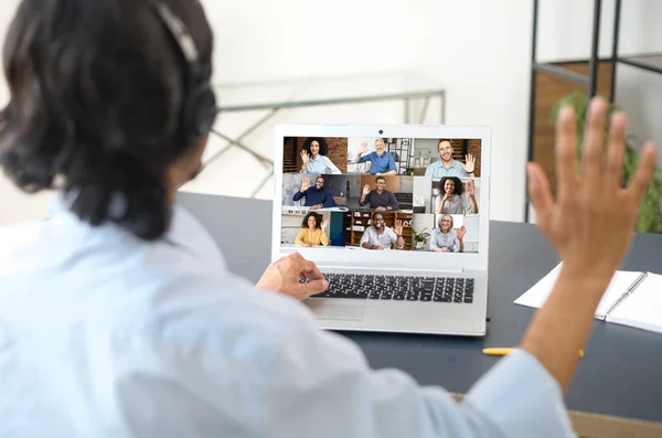 View from back on an indian man using laptop for video connection