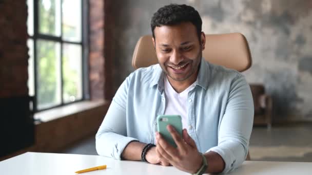 Joyful indian man talking by video call on the smartphone — Stock Video