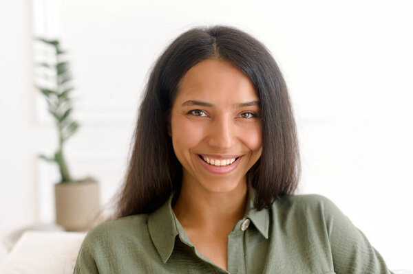 Close-up portrait of serene beautiful indian dark-haired woman